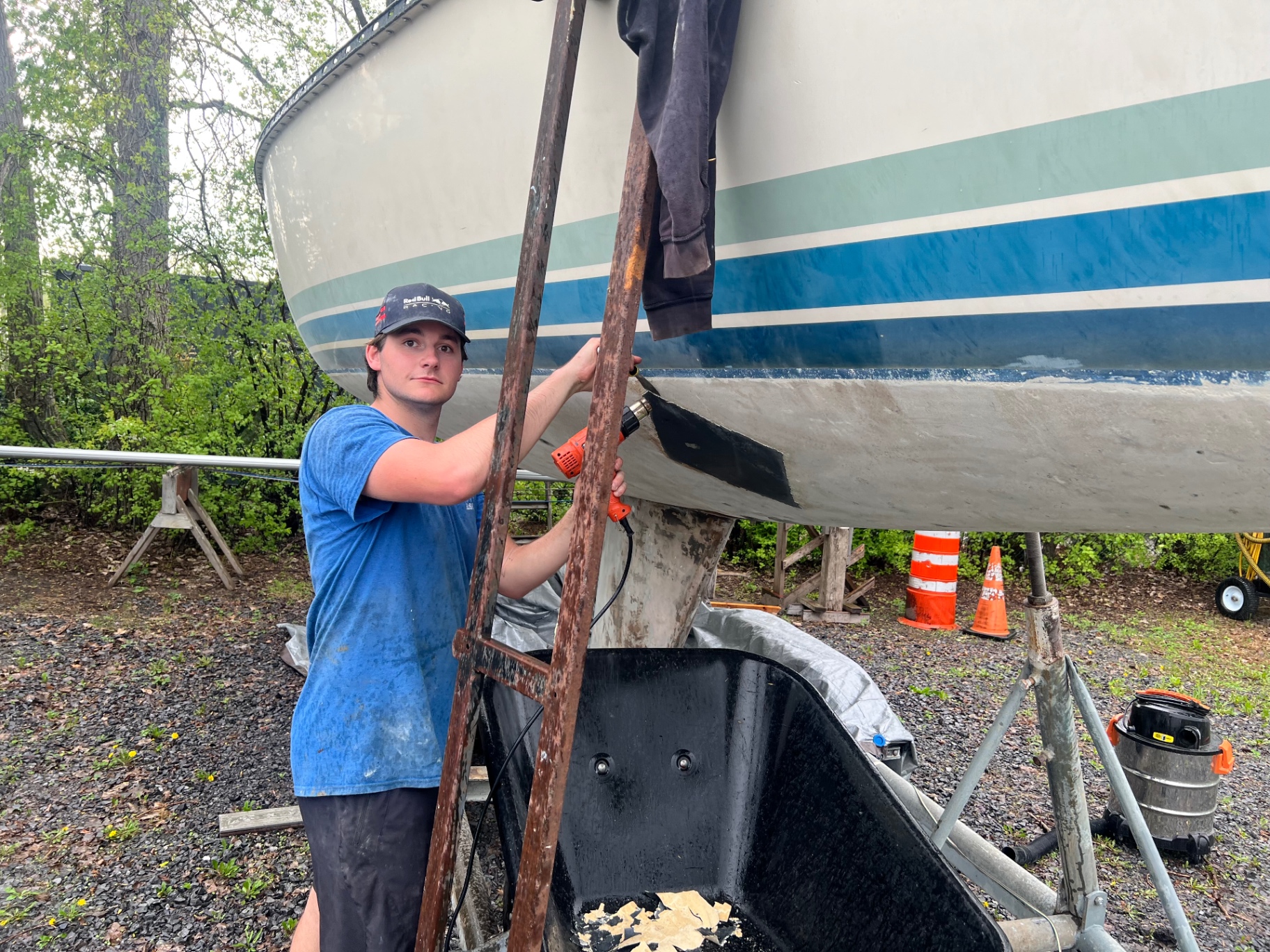 Eric Parkhill performing hands-on boat maintenance under a hull.